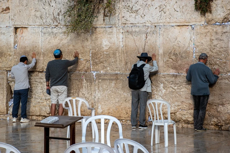a group of men standing next to each other near a wall, by Elias Goldberg, shutterstock, holy place, scratches on photo, tending on arstation, 2019 trending photo