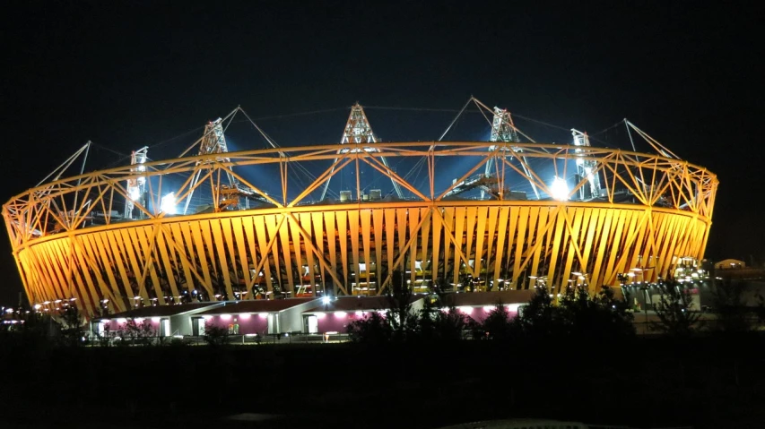 the olympic stadium is lit up at night, a picture, by Joseph Severn, flickr, golden windows, yard, summer evening, astonishing detail