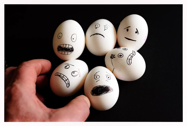 a person holding a bunch of eggs with faces drawn on them, tumblr, shock art, ffffound, various emotions, stop - motion, high-contrast
