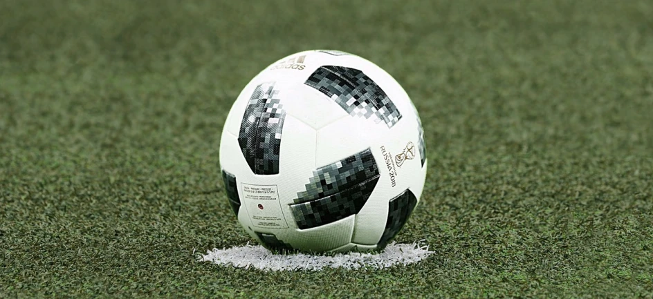 a soccer ball sitting on top of a soccer field, a picture, inspired by Sava Šumanović, confetti, black on white, afp, mid closeup