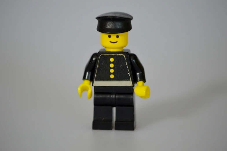 a close up of a lego man wearing a uniform, a picture, inspired by Ernest Buckmaster, figuration libre, wearing black dress and hat, no logo!!!, mid 2 0's female, lemon