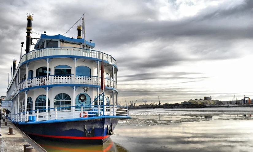 a large boat sitting on top of a body of water, by Julian Fałat, flickr, buenos aires, blue and gray colors, the morning river, farol da barra