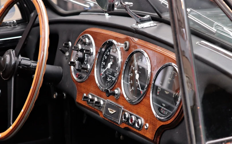 a close up of a dashboard of a car, by David Simpson, pexels, modernism, vintage aston martin, a wooden, hyper-realistic render, bentley