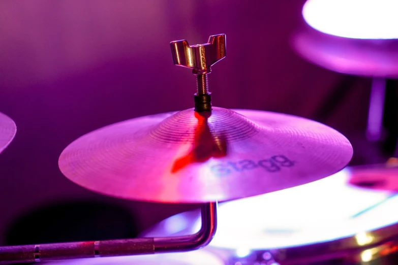 a close up of a drum on a stage, by Jens Søndergaard, high hat, fuschia leds, detailed picture, beginner