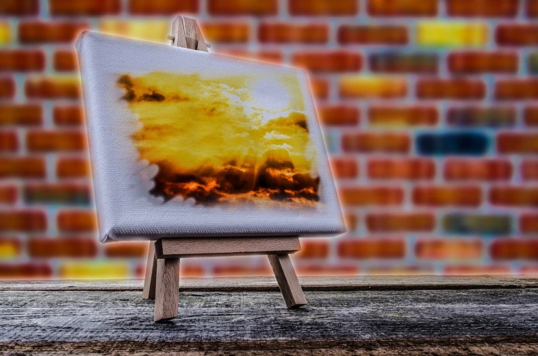 an easel with a painting on it in front of a brick wall, a fine art painting, inspired by Frederic Edwin Church, shutterstock contest winner, nuclear art, burning clouds, digital art. highly detailed, background in blurred, airbrush on canvas