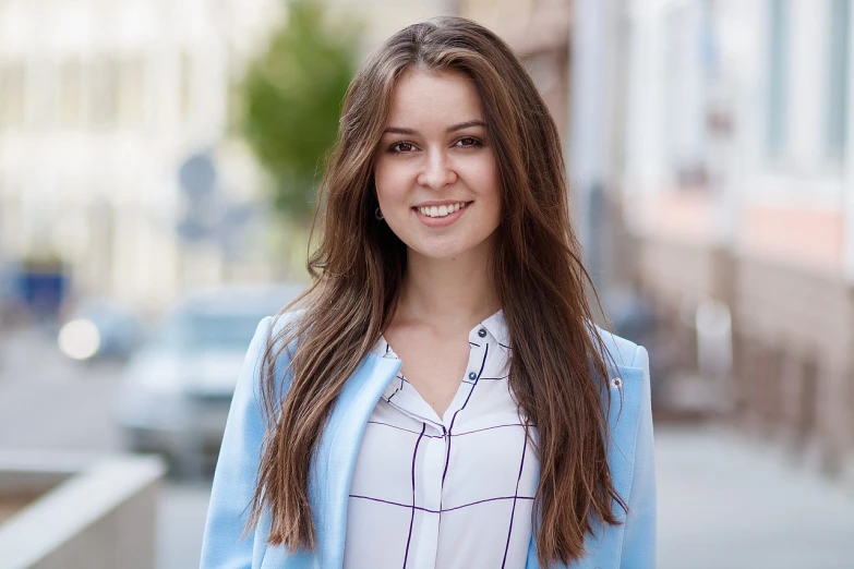 a beautiful young woman standing on a city street, by Maksimilijan Vanka, shutterstock, wearing a light blue shirt, wearing a blazer, beautiful long brown hair, with a bright smile