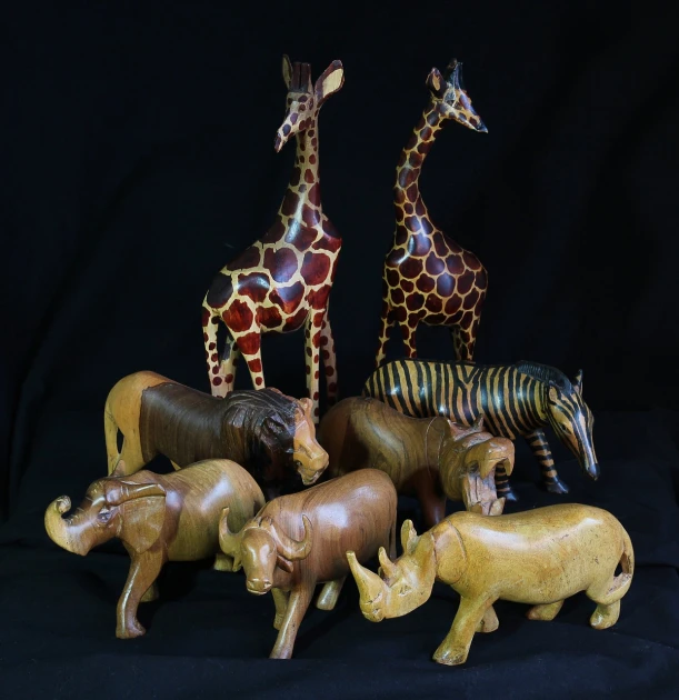 a group of animal figurines sitting next to each other, by Linda Sutton, sumatraism, decorated polished wood, safari, full - view, animal skins