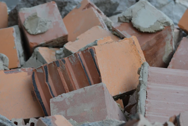 a pile of bricks sitting on top of a pile of cement, a picture, by Stefan Gierowski, shutterstock, plasticien, buildings collapsed, close - up photo, stock photo, collapsed ceiling