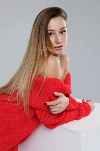 a woman in a red sweater posing for a picture, trending on cg society, sexy girl with long blonde hair, high angle close up shot, on a white table, half body photo