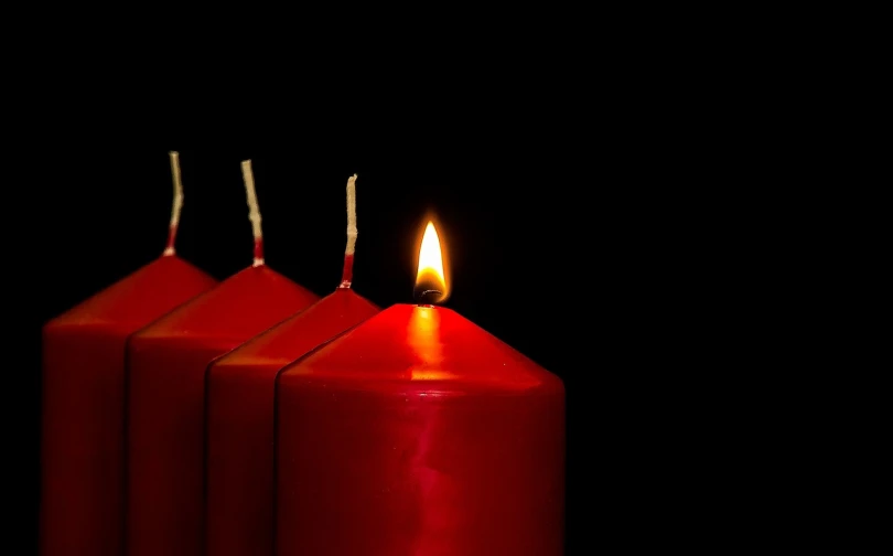 a group of three red candles sitting next to each other, a photo, pixabay, in a row, four, epiphany, shot with a dslr