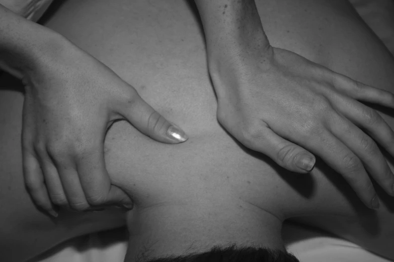 a woman with her hands on the back of a man, a black and white photo, by Amelia Peláez, flickr, massurrealism, acupuncture treatment, over the shoulder closeup, hand controlling, summer night