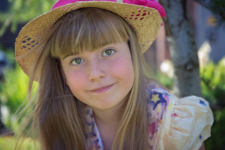 a close up of a child wearing a hat, a portrait, by Arnie Swekel, pixabay contest winner, young beautiful hippie girl, straw hat, young teen, 4 0 9 6