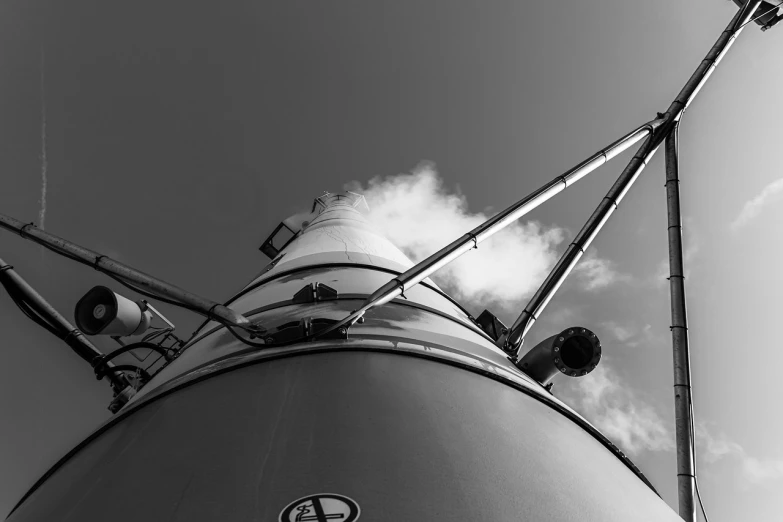 a black and white photo of a tower, a black and white photo, inspired by Alfred Eisenstaedt, unsplash, saturn v, steam engine, high detail photo, galaxy