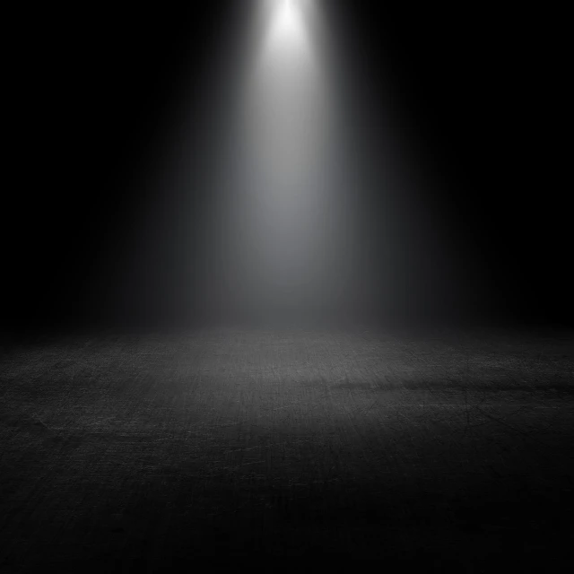 a black and white photo of a light in the dark, light and space, arena background, dusty floor, volumetric fog resolution, spotlight at a 90 degree angle