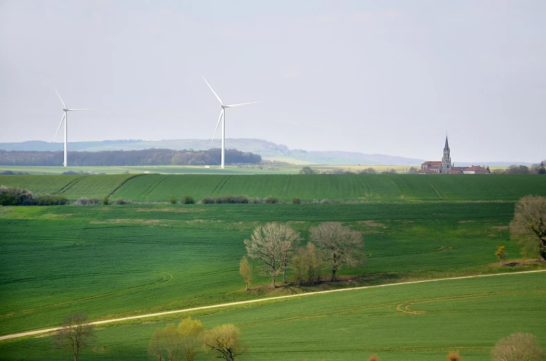 a green field with wind turbines in the distance, a picture, by Karl Hagedorn, view of villages, flanders, spring early, well balanced composition