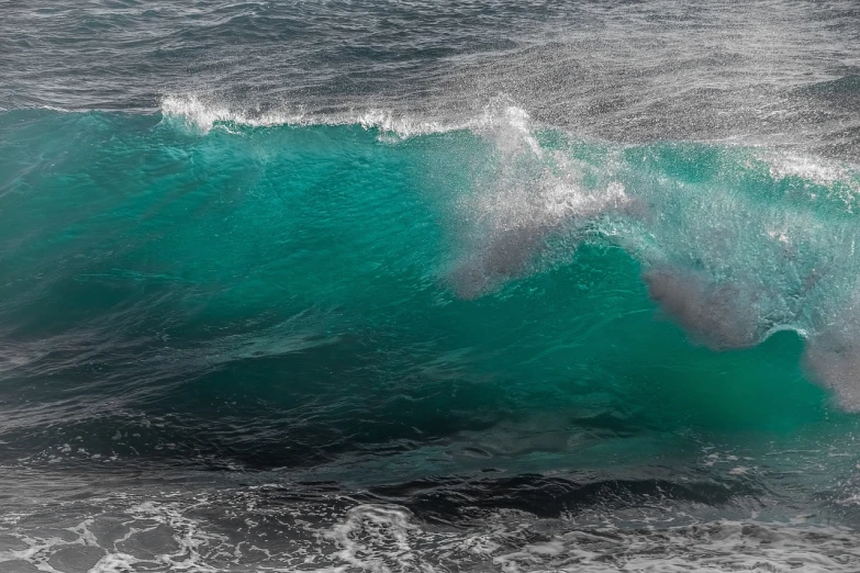 a man riding a wave on top of a surfboard, a picture, by Hans Schwarz, shutterstock, fine art, turquoise color scheme, the blue whale crystal texture, ocean cliff side, stock photo