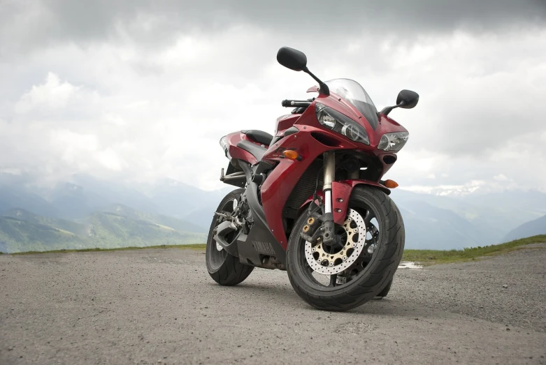 a red motorcycle parked on the side of a road, shutterstock, highly detailed product photo, on the mountain, high detail product photo, stock photo