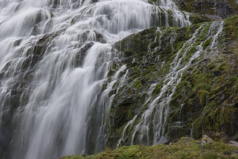 a man standing in front of a waterfall, by Jørgen Nash, shutterstock, blurred detail, 2 0 0 mm telephoto, silk flowing in wind, very very well detailed image