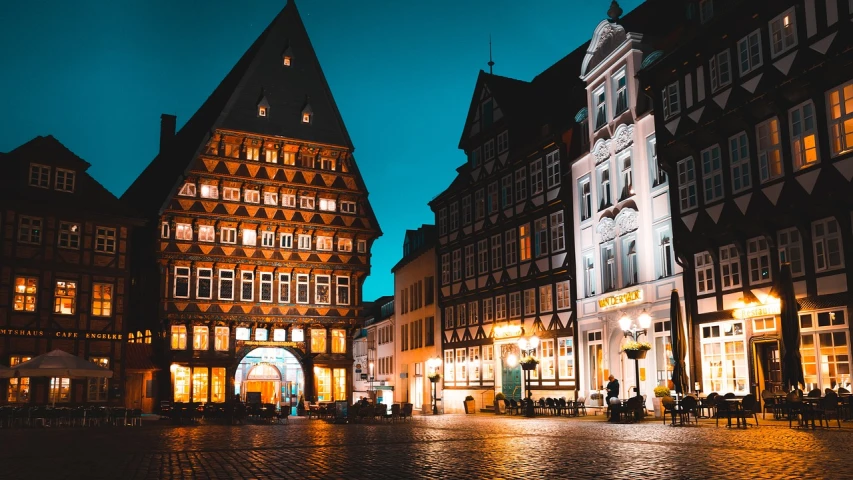 a cobblestone street in a european city at night, a picture, by Tobias Stimmer, pexels, renaissance, lower saxony, a wide open courtyard in an epic, thatched houses, market place