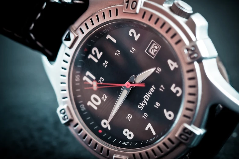 a close up of a watch on a black surface, a stock photo, by Andrei Kolkoutine, captain, adventurer, in style of mike savad”, high details photo