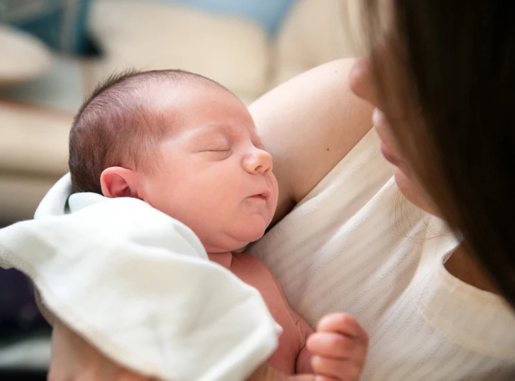 a woman holding a baby in her arms, a picture, by Joseph Severn, shutterstock, the birth, close establishing shot, istockphoto, asleep