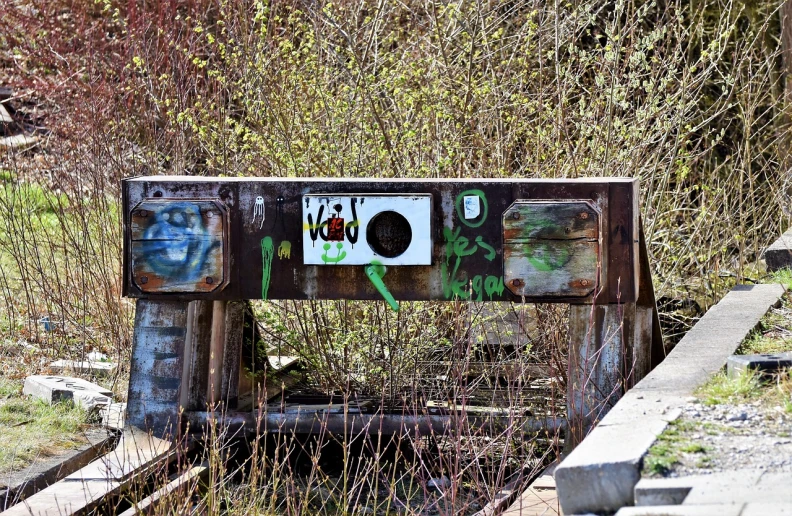 a close up of a bridge with graffiti on it, inspired by Wolf Vostell, flickr, ghetto blaster, entrance to abandoned mine, warm spring, yolo