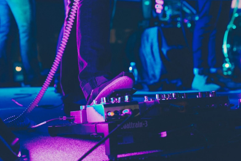 a close up of a person standing on a stage, a picture, jamming to music, cable plugged into cyberdeck, blue shoes, ergodox