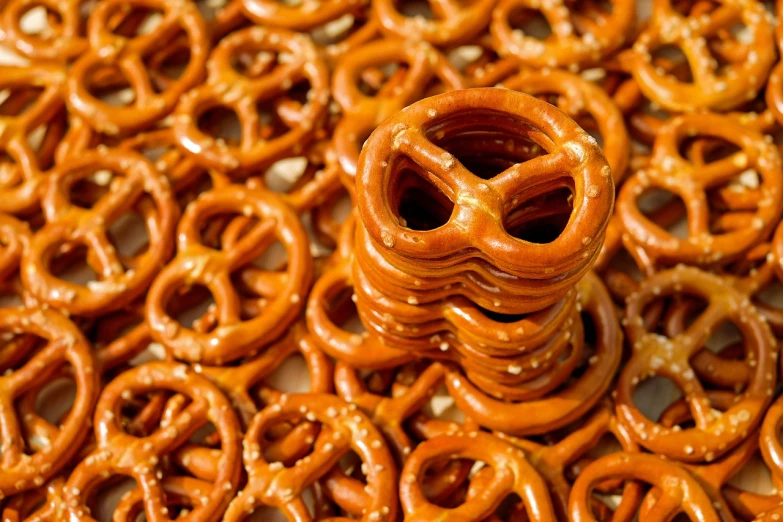 a pile of pretzels sitting on top of a table, pexels, process art, circle eyes, background image, stock photo, from wheaton illinois
