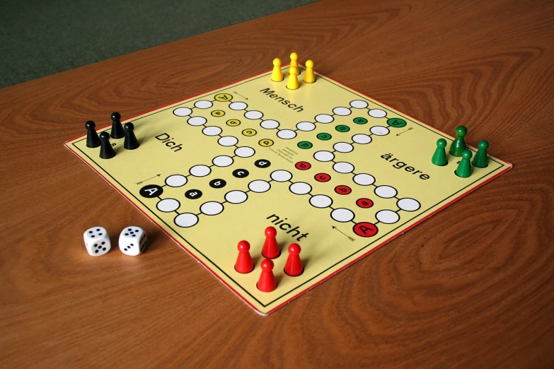 a board game sitting on top of a wooden table, by Anita Kunz, pixabay, bauhaus, on a yellow paper, whitehorns, duel, taken in the late 2000s