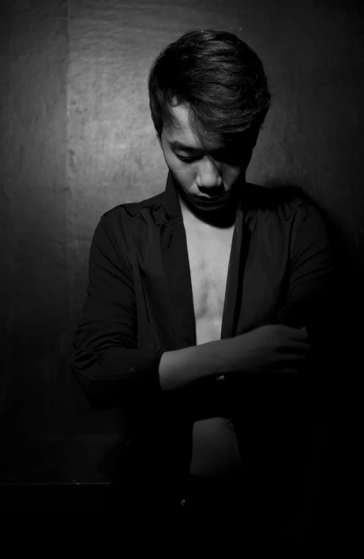 a black and white photo of a man with his arms crossed, a black and white photo, inspired by David Diao, tumblr, dim lighting!!!, fashion portrait photo, keng lye, monochrome:-2