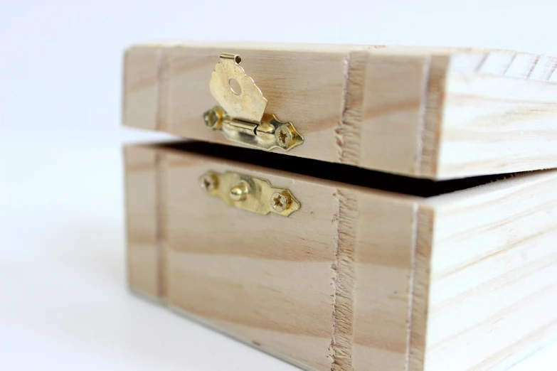 a wooden box sitting on top of a table, process art, shiny knobs, set against a white background, close up shot from the side, joints