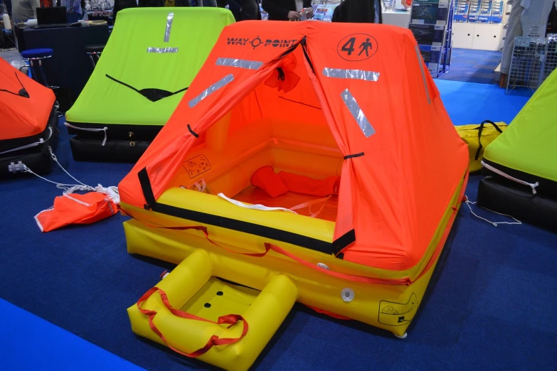 a group of life rafts sitting on top of a blue floor, a photo, by Walenty Wańkowicz, shutterstock, tent, all enclosed in a circle, hivis, mini model