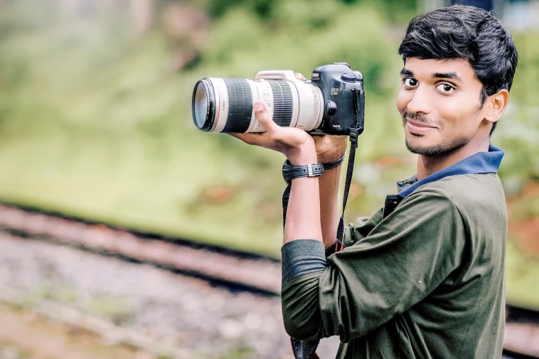 a man taking a picture with a camera, inspired by Steve McCurry, art photography, canon- 70-200mm lens, jayison devadas style, half body photo, professional wedding photography