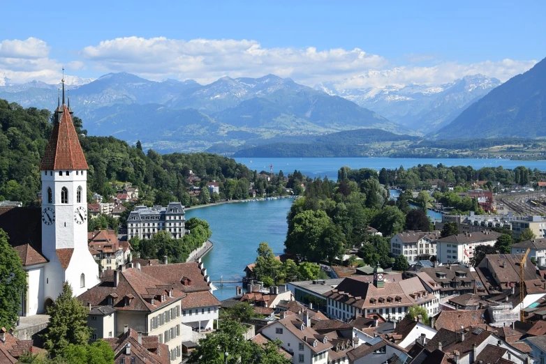 a view of a town with a lake and mountains in the background, a picture, by Karl Stauffer-Bern, shutterstock, a high angle shot, alana fletcher, stock photo, detailed picture