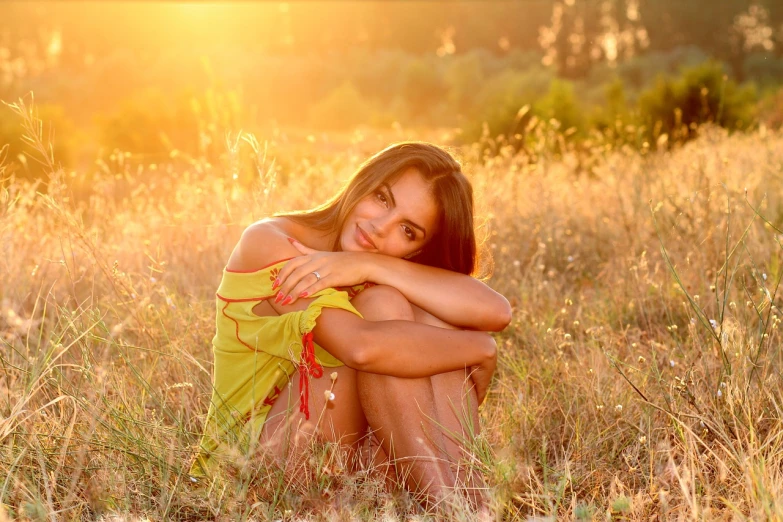 a woman sitting in a field of tall grass, a picture, by Aleksander Gierymski, pixabay, cute seductive smile, golden glow, with beautiful exotic, sitting relax and happy