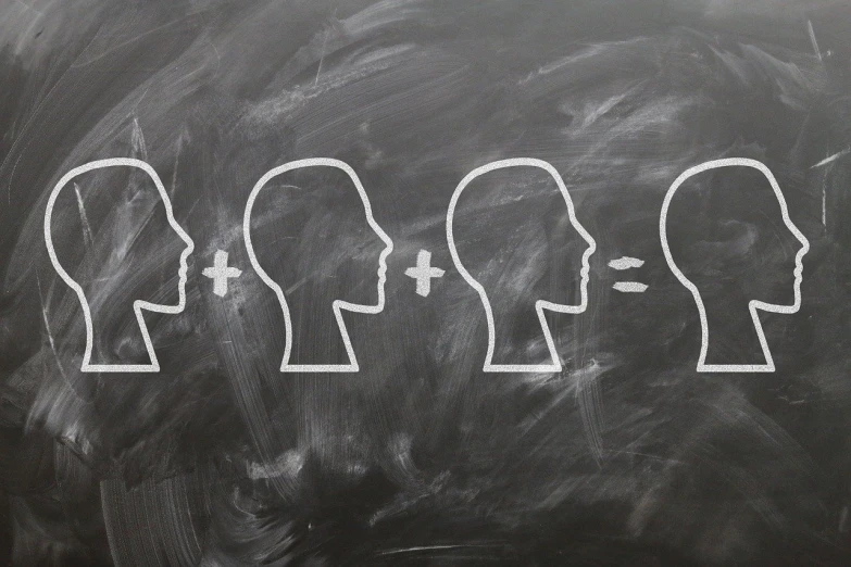 a group of heads drawn in white chalk on a blackboard, a picture, by Adam Szentpétery, trending on pixabay, precisionism, balancing the equation, outlined silhouettes, facing each other, brains