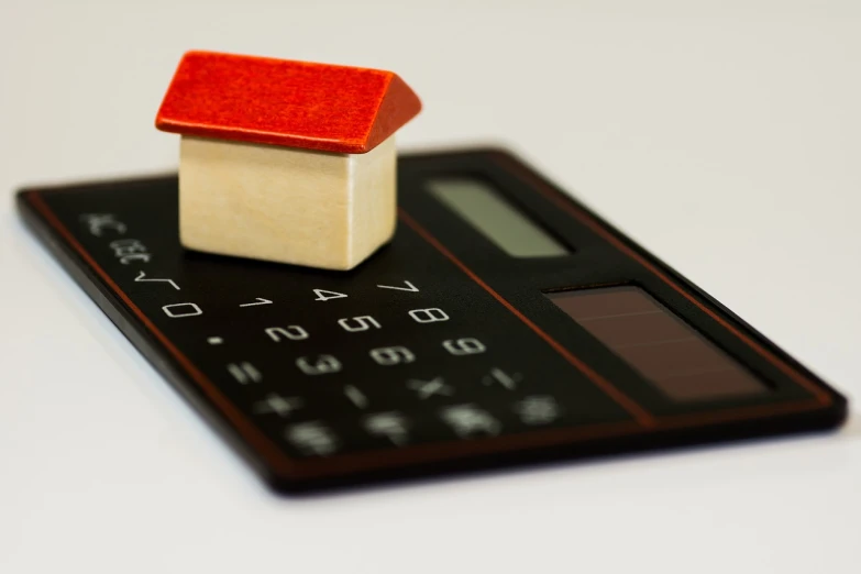 a miniature house sitting on top of a calculator, a photo, modernism, black and red color scheme, miniature product photo, 1 7 8 0, :6