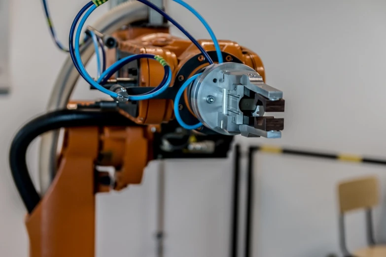 a close up of a robot in a room, industrial photography, profile close-up view, close up shot from the top, side view of a gaunt