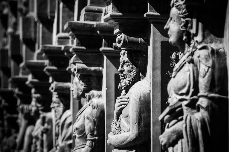 a black and white photo of a row of statues, a statue, by John Murdoch, trending on pixabay, baroque, the temple of truth is white, vivid and detailed, sculpture of moloch, taken with sony alpha 9