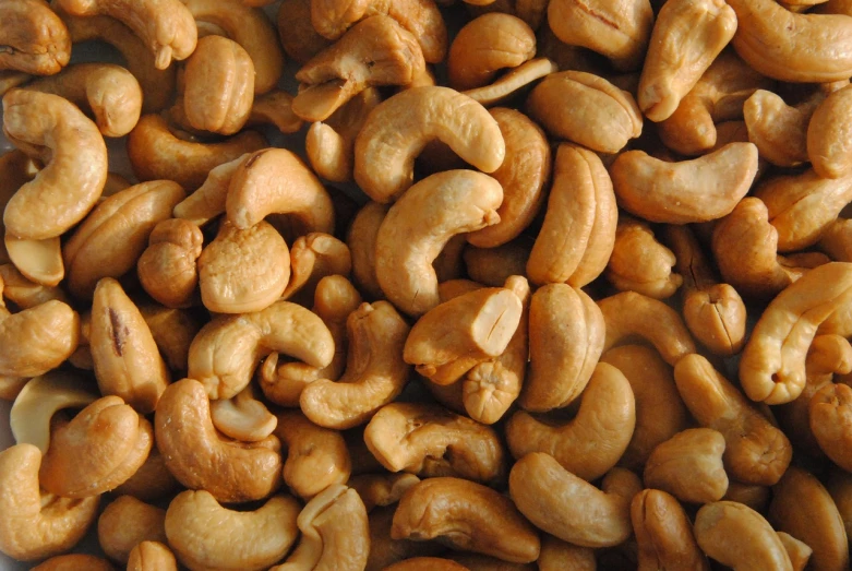 a pile of cashews sitting on top of a white plate, by Josef Navrátil, high resolution texture, wikipedia, close-up product photo, avatar image