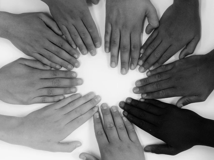 a group of people holding hands in a circle, a black and white photo, 15081959 21121991 01012000 4k, black skin!!!, (heart), advertising photo