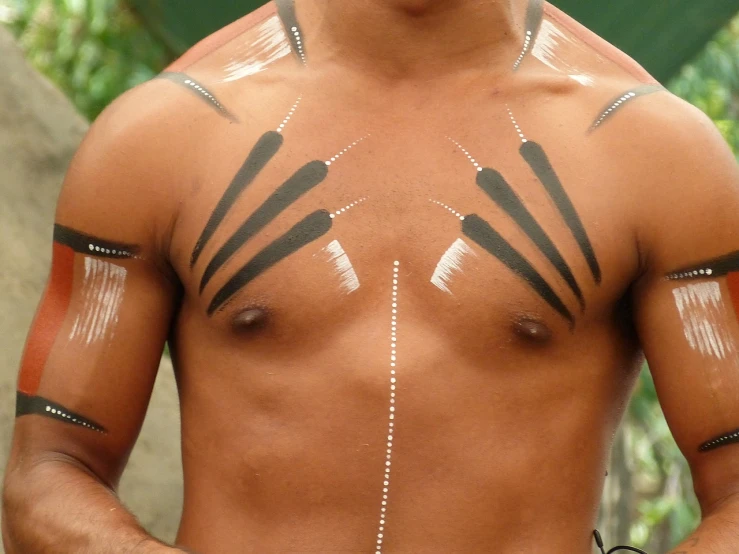 a close up of a man with tattoos on his chest, by Antônio Parreiras, flickr, hurufiyya, ceremonial ritual, airbrush painted, palm lines, on set