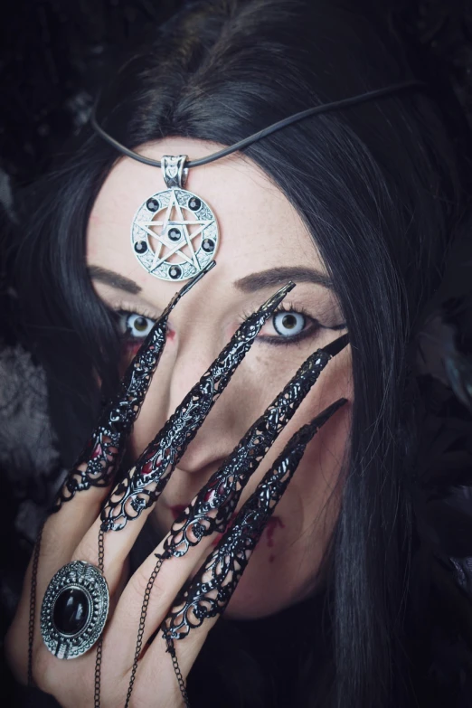 a close up of a person with long black hair, a photo, inspired by Anne Stokes, tumblr, gothic art, 3 d render of a shaman, jewelry photography, nagash editorial, pentagrams