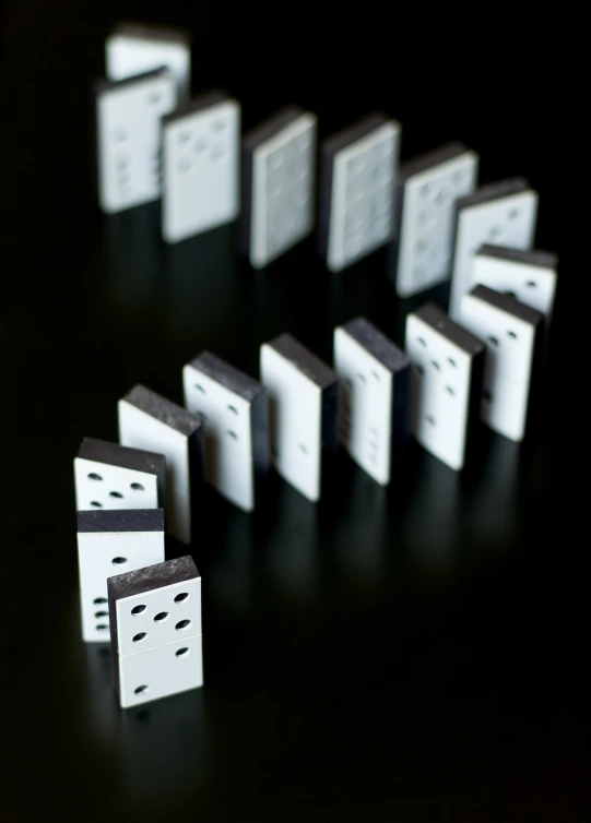 a group of dominos sitting on top of a table, a stock photo, by Andrew Domachowski, digital art, rows of doors, white on black, which splits in half into wings, telephoto shot