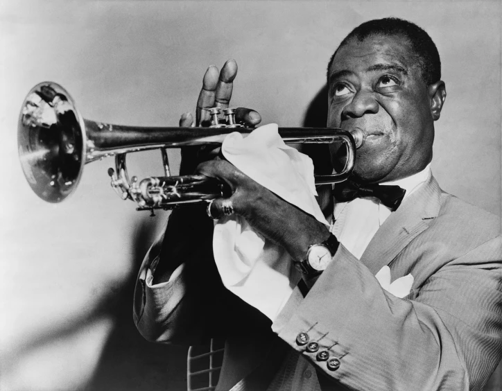 a black and white photo of a man playing a trumpet, a black and white photo, pixabay, harlem renaissance, while smiling for a photograph, restored color, 🦩🪐🐞👩🏻🦳, the rock and roll emperor