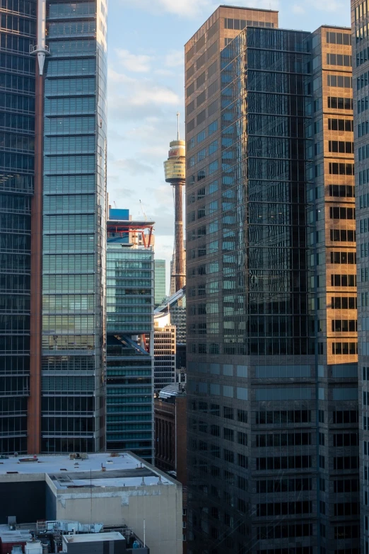 a group of tall buildings sitting next to each other, inspired by Sydney Carline, shutterstock, hurufiyya, seen through a window, 2 4 mm iso 8 0 0 color, “ golden chalice, shot on nikon z9