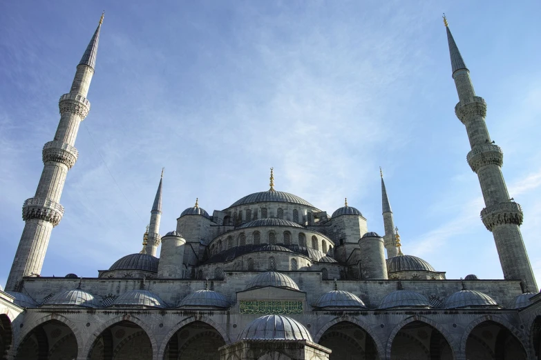 a group of people standing in front of a large building, by January Suchodolski, flickr, hurufiyya, with great domes and arches, blue and gray colors, istanbul, snail