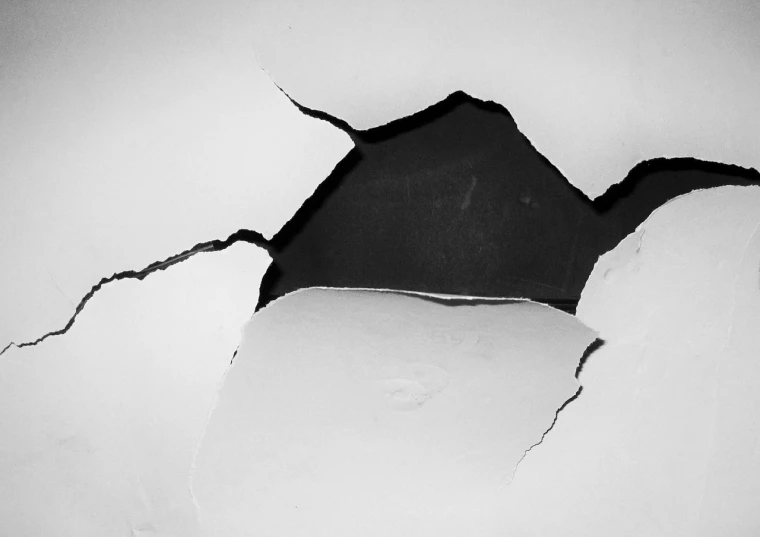 a black and white photo of a hole in a wall, a photo, pexels, minimalism, damage paper, porcelain forcefield, fault, wallpaper - 1 0 2 4