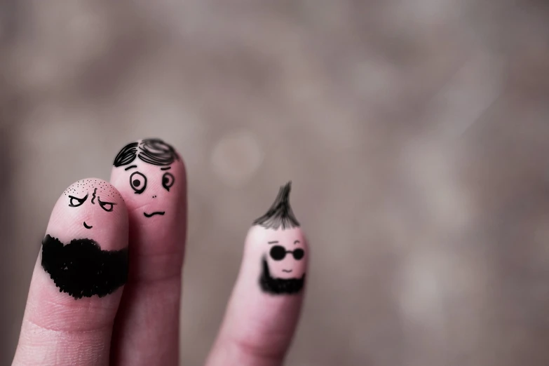 a couple of fingers with faces painted on them, a picture, by Emma Andijewska, pexels, hipster dad, charicature, depeche mode, three dwarf brothers