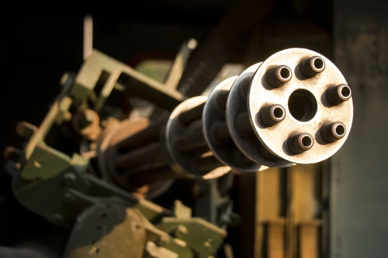a close up of a machine gun on display, a picture, by Thomas Häfner, shutterstock, shot at golden hour, missle turrets, shot from below, header